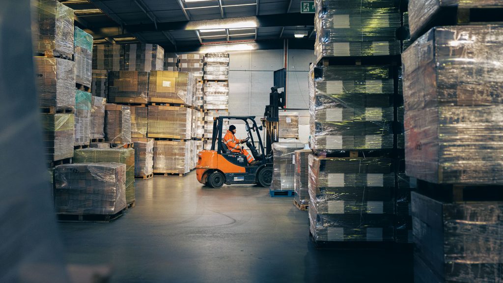 Professional 3pl warehousing. Image shows fork lift truck moving pallets in a warehouse.