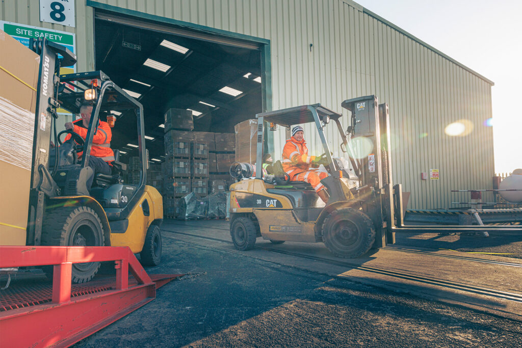 Experienced fork lift drivers moving stock at the GWS warehouse storage facility.