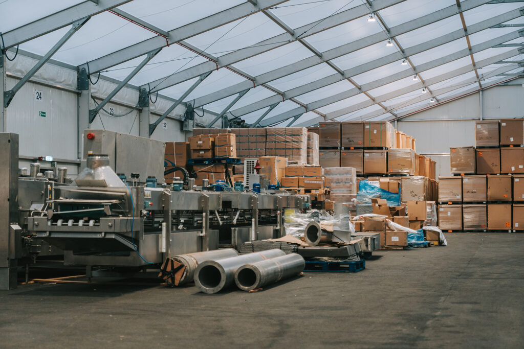 Image shows a warehouse with machinery parts