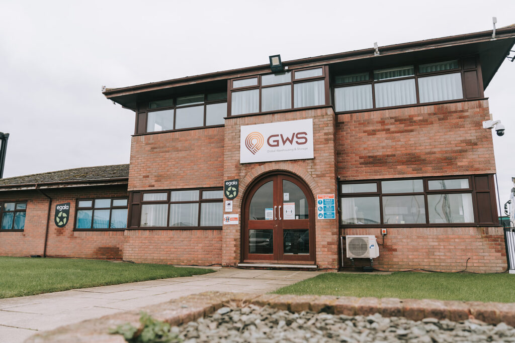 Image shows a brown brick building the headquarters of GWS warehousing and storage. Their logo appears above the door.