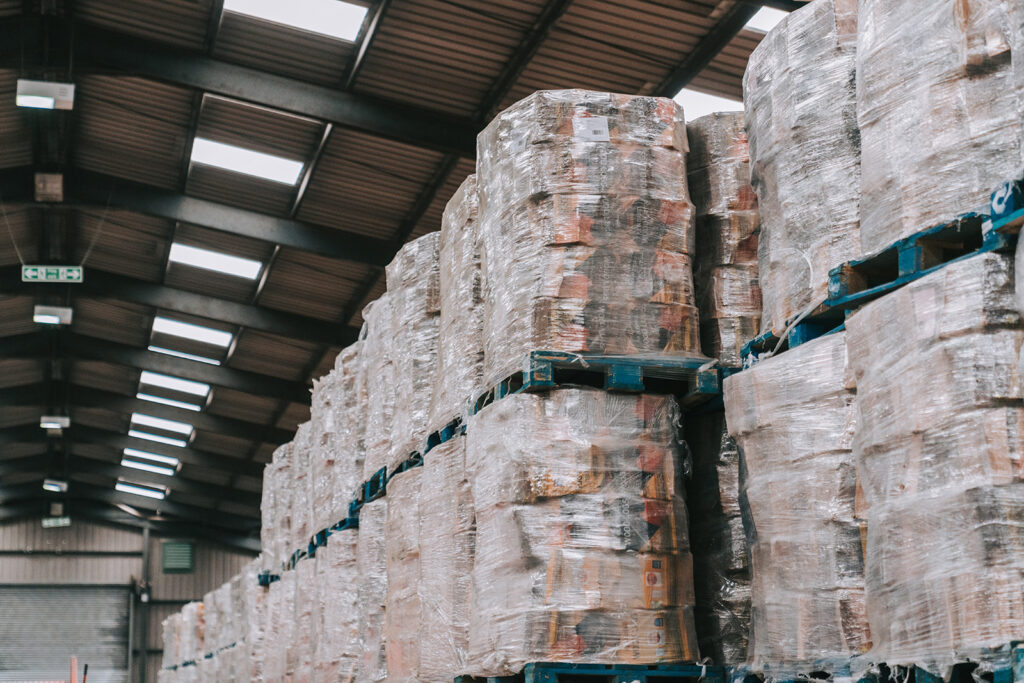 Image shows pallets of wood in a secure warehouse